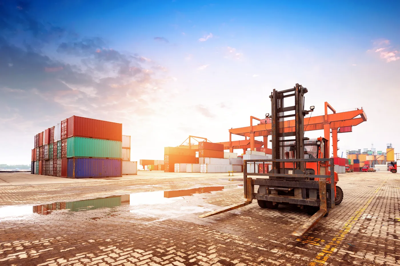 Forklift and shipping containers at a cargo terminal